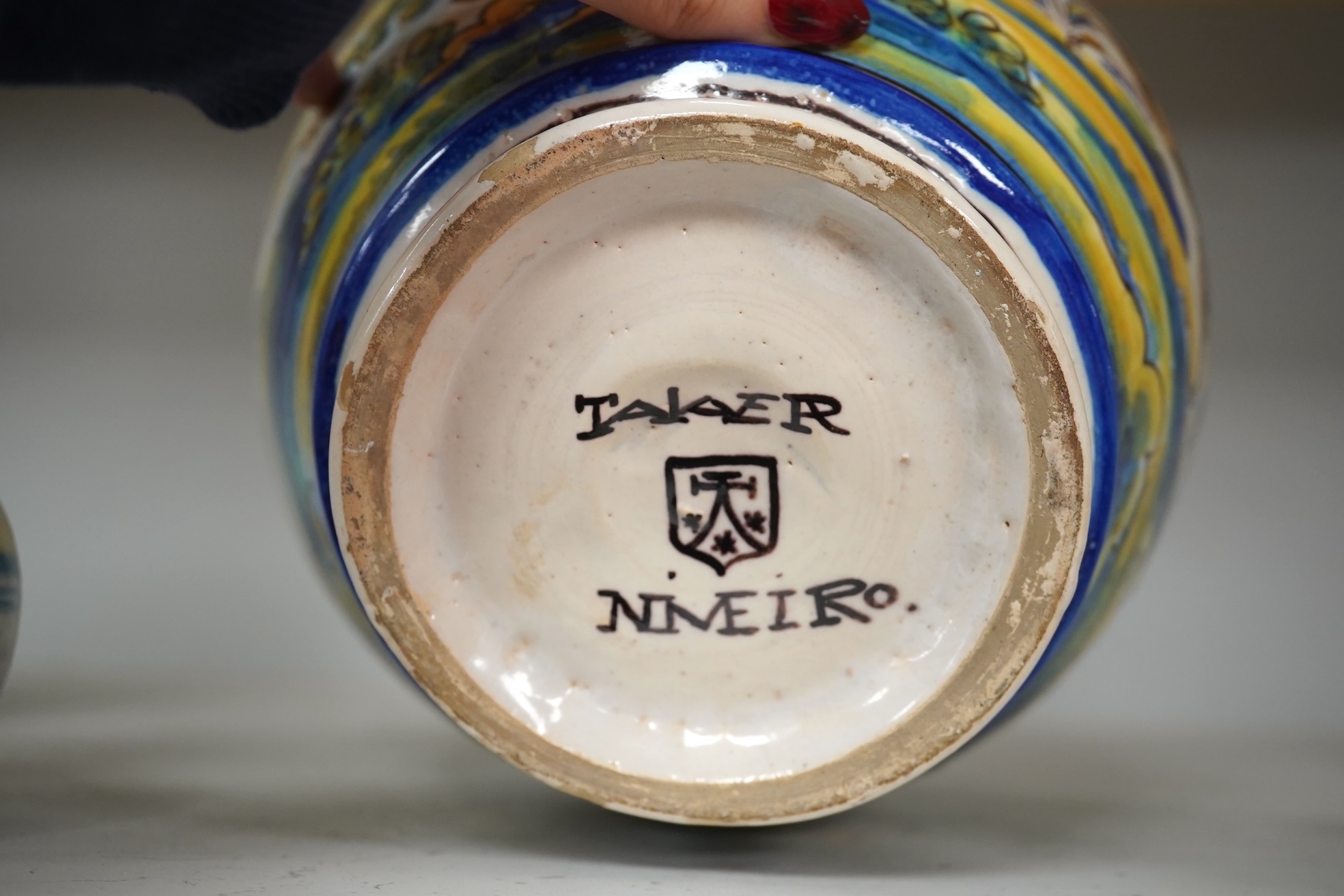 An Italian maiolica teapot and jug and a Talavera maiolica vase, 25cm high (3). Condition - jar good, teapot restored and cracked